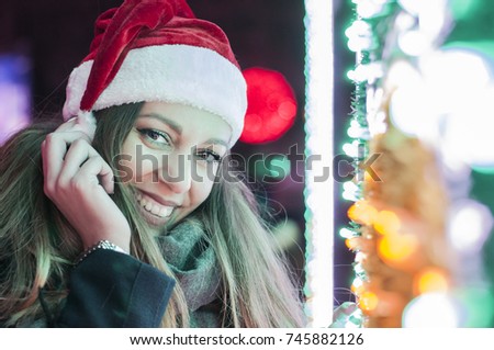 Beautiful brunette woman in santa hat. Portrait of beautiful girl. Winter portrait of young beautiful brunette woman. Christmas woman