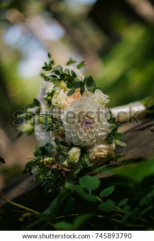 bridal bouquet of the bride lies on the grass. Picture of a wedding bouquet. A bouquet of the bride on the grass. The bride's bouquet
