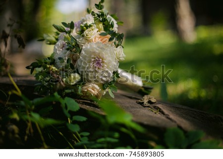bridal bouquet of the bride lies on the grass. Picture of a wedding bouquet. A bouquet of the bride on the grass. The bride's bouquet