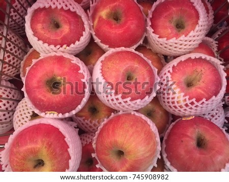 An apple is a round fruit with red or green skin and a whitish inside. One variety of apple might be sweet, another sour.