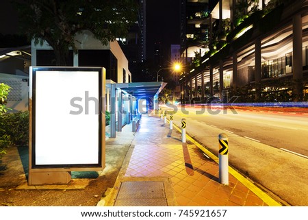 blank billboard on street in midtown of singapore at night