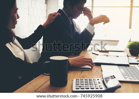 Businessman feel sad worry tired frustrated upset fail after lost work job from office . he become unhappy and depressed person But a colleague cheering alongside.