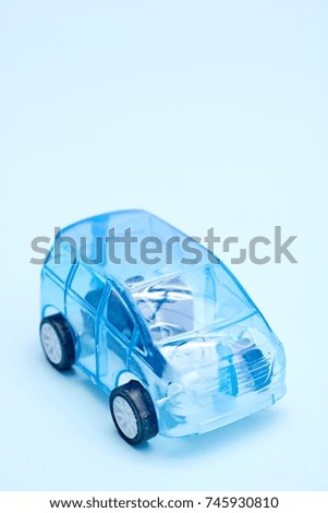 A studio photo of a llittle blue car