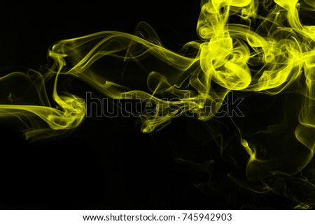Yellow smoke abstract on black background, darkness concept