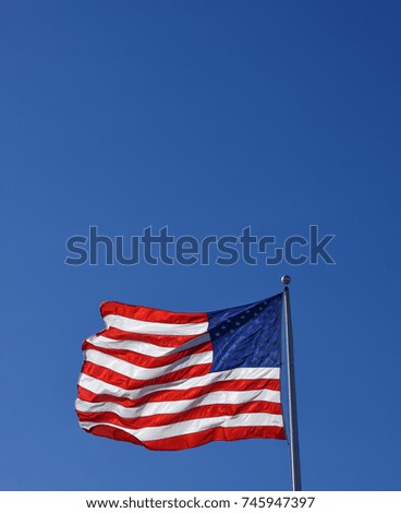 Beautiful United States of America Flag with clear blue sky copy space background