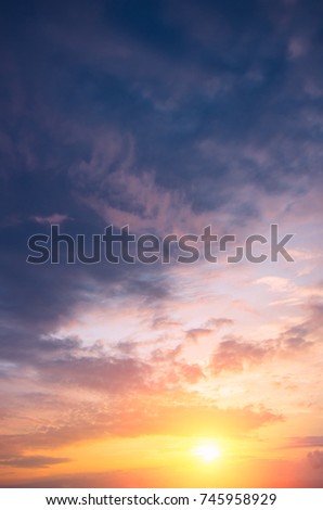 Beautiful autumn sunset with bright sun and colorful clouds. Natural dawn composition