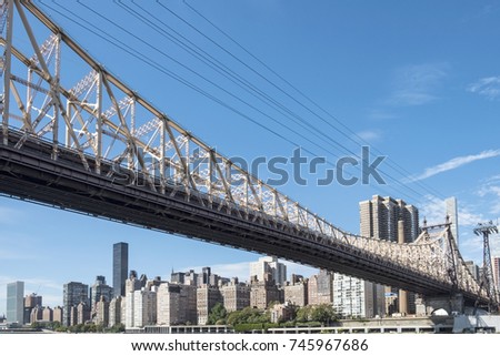 exterior of Queensboro bridge and tramway cable against Manhattan skyline , New York