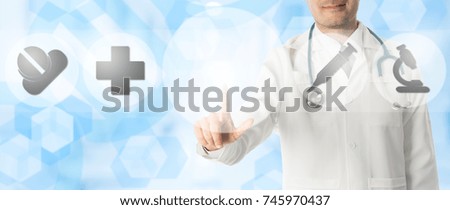 Medical Concept - Doctor points at copy space with icons showing symbol of research innovation for healthcare technology on blue abstract background.
