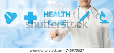 Medical Healthcare Concept - Doctor points at health icons showing symbol of medicine, medical cross and hospital lab research against blue abstract background.