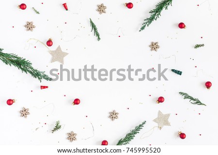 Christmas composition. Frame made of christmas tree branches, golden decorations and red berries on white background. Flat lay, top view, copy space