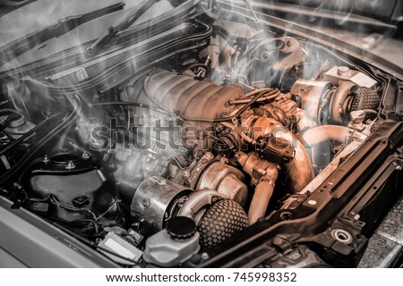 Overheated muscle car engine Royalty-Free Stock Photo #745998352