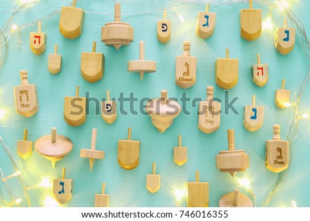 Top view Image of jewish holiday Hanukkah with wooden dreidels colection (spinning top).