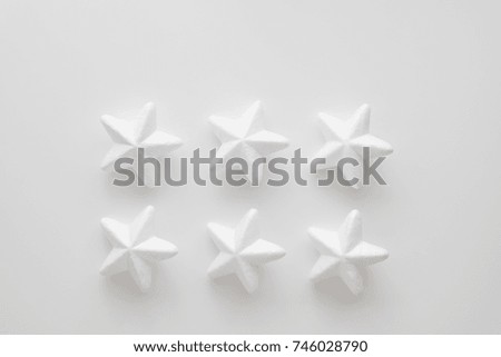 Christmas and New Year holiday composition with white stars on the background. Top view, flat lay. Copyspace