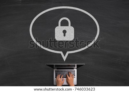 Internet Security concept with hands typing laptop on the blackboard background.