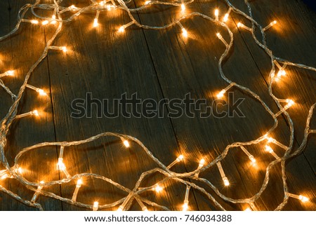 Electric lighted  on wooden background Christmas rustic background - vintage planked wood with lights and free text space