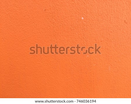 Orange color concrete wall background for texture design