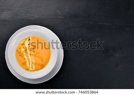 Pumpkin Soup. On a wooden surface. Top view. Free space for your text.