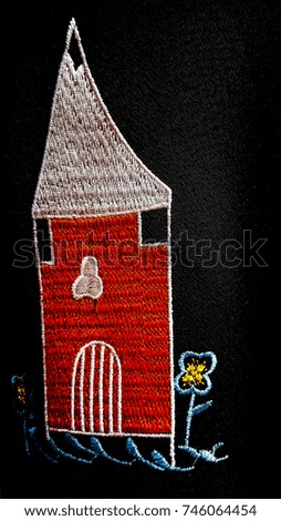 Red house with white roof in flower garden  sew embroidery  on black background 