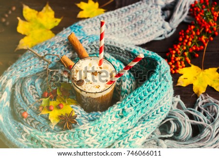 Autumnal concept with bright yellow leaves and cup of coffee  in rustic style with copyspace