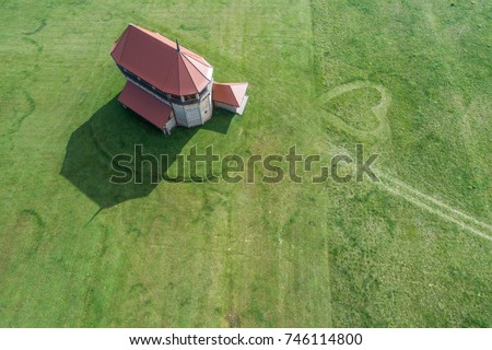 Wooden church with heart shape in grass