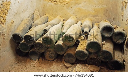 Warehouse of old bottles for wine in an abandoned barn, in dust