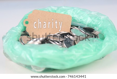 Photo for coins in plastic with text charity on small tag