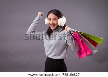 portrait of happy exited woman shopper holding shopping bag