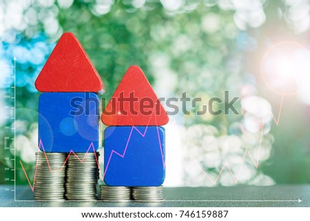 Stacks of coins and account book or credit card with financial graph, real estate investment and saving banking money finance concept.