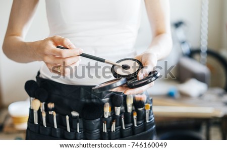 professional make-up artist with a belt bag with tassels. makeup brushes. Royalty-Free Stock Photo #746160049