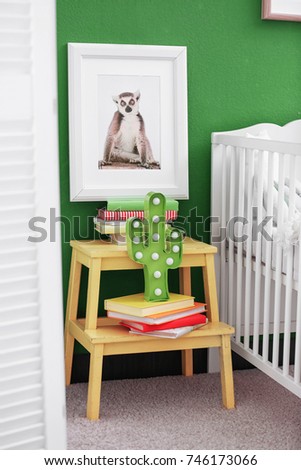 Picture of cute monkey and stand with books in child's room