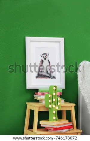 Picture of cute monkey and stand with books in child's room