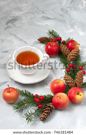 Christmas gift card with holiday composition: tea cup, apples and fir tree branches