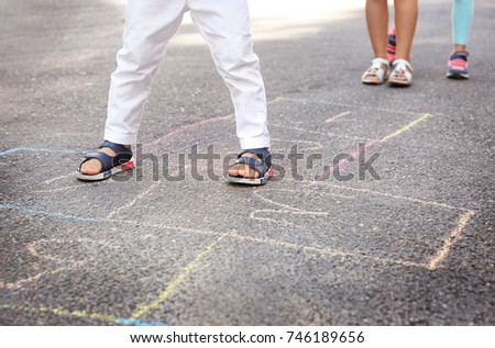 Children playing hopscotch outdoors