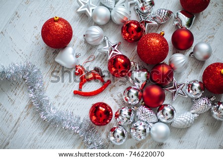 Christmas tree decoration on white wood background.Red and silver balls and daubles close-up.New Year preparation