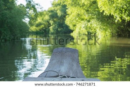 Wooden boat in the river forest.