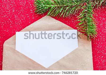 Mockup of christmas envelope with paper. Xmas background with fir tree and snow flakes.