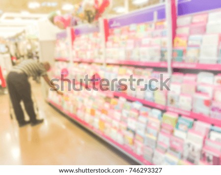 Blurred image verity greeting cards on display at a retail store in America. Customer select seasonal and holiday card for event such as Happy Birthday, Happy New Year, Merry Christmas, etc.