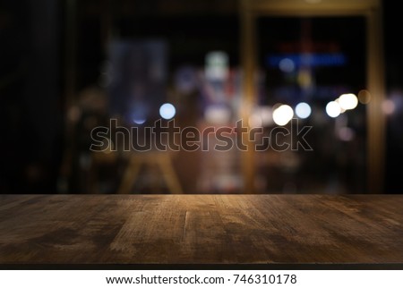 Empty dark wooden table in front of abstract blurred bokeh background of restaurant . can be used for display or montage your products.Mock up for space Royalty-Free Stock Photo #746310178
