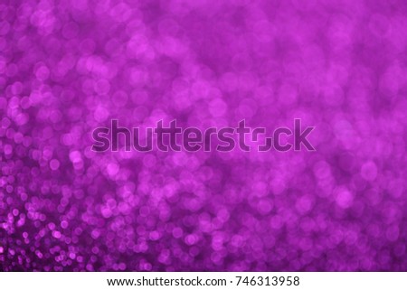 Abstract background of purple glittering defocused lights.