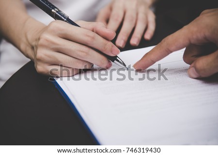 Women people hand signing a contract on document for building house economic with architect man and partner person.  Contract and partnership Concept.