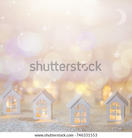 Christmas cityscape with small houses and starry garlands. 