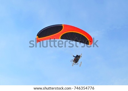 Paragliding in the blue sky in a Sunny clear weather
