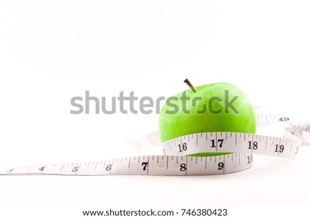 The isolated of an apple green and measuring tape over white background. weight loss and healthy eating style concept. 