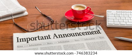 A newspaper on a wooden desk - Important announcement Royalty-Free Stock Photo #746383234