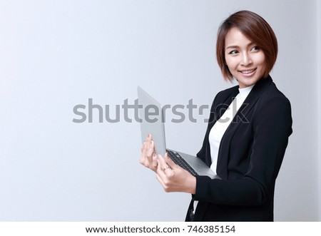 Beautiful woman holding laptop in hands, white background.