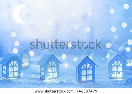 Soft selective focus, holiday background with small wooden houses and star garlands. Christmas, birthday, New Year or Valentine's day concept.