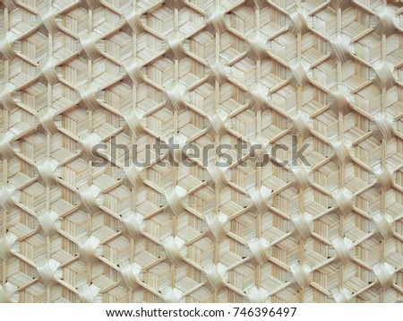 The Closeup Shot at The Surface of Handmade Bamboo Weaving with Traditional Pattern / Texture for Background, Backdrop or Wallpaper.