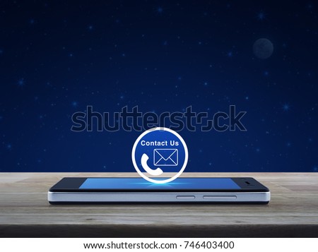 Telephone and mail icon button on modern smart phone screen on wooden table over fantasy night sky and moon, Contact us concept