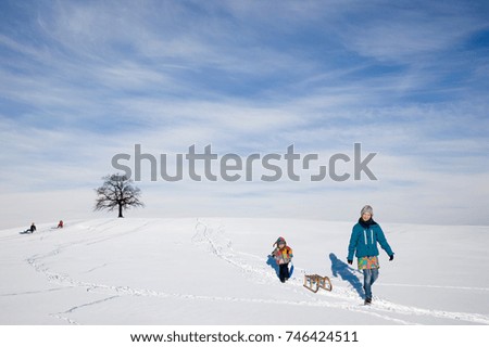 Boy and Girl with a sledge in snow