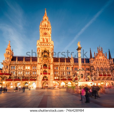Impressive evening view of Marienplatz - City-center square & transport hub with towering St. Peter's church, two town halls and a toy museum, Munich, Bavaria, Germany, Europe.